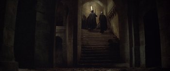 Movie still from “The Lion in Winter” (1968), directed by Anthony Harvey – A group of people walking down a set of stairs; Wide shot, High angle