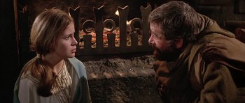 Movie still from “The Lion in Winter” (1968), directed by Anthony Harvey – A man and a woman standing next to each other in front of a fire place; Close Up shot, Over the shoulder angle