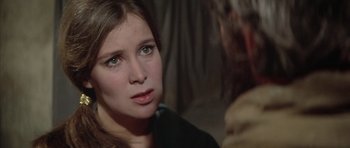 Movie still from “The Lion in Winter” (1968), directed by Anthony Harvey – A young woman looking at the camera while a man looks at her; Close Up shot, Over the shoulder angle