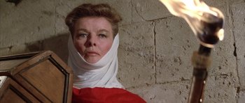 Movie still from “The Lion in Winter” (1968), directed by Anthony Harvey – An older woman wearing a head scarf and a red dress; Close Up shot, Low angle