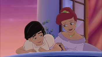 Movie still from “The Little Mermaid II: Return to the Sea” (2000), directed by Bill Speers – Two animated women sitting next to each other on a bed; Medium shot, Over the shoulder angle