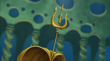 Movie still from “The Little Mermaid II: Return to the Sea” (2000), directed by Bill Speers – An image of an image of a statue of a trident; Extreme Close Up shot, Overhead angle