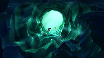 Movie still from “The Little Mermaid II: Return to the Sea” (2000), directed by Bill Speers – An underwater cave with a person swimming in it; Extreme Wide shot, High angle