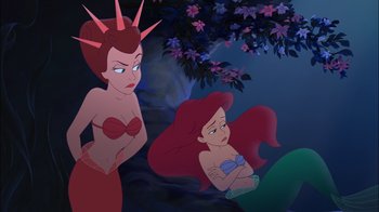 Movie still from “The Little Mermaid: Ariel's Beginning” (2008), directed by Peggy Holmes – A couple of women sitting next to each other in a forest; Medium shot, Over the shoulder angle