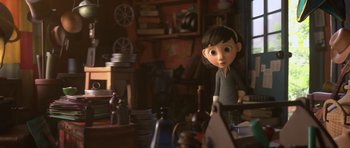 Movie still from “The Little Prince” (2015), directed by Mark Osborne – A girl is standing in front of a table; Medium shot, Over the shoulder angle