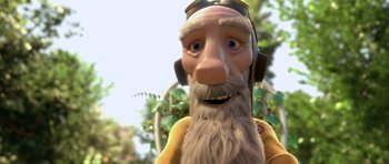 Movie still from “The Little Prince” (2015), directed by Mark Osborne – An animated bearded man wearing headphones with trees in the background; Close Up shot, Low angle