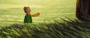 Movie still from “The Little Prince” (2015), directed by Mark Osborne – A little boy in a green shirt is holding a frisbee; Medium shot, Low angle