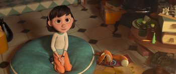 Movie still from “The Little Prince” (2015), directed by Mark Osborne – A girl is sitting on a pillow next to a stuffed animal; Wide shot, High angle