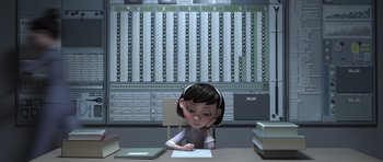 Movie still from “The Little Prince” (2015), directed by Mark Osborne – A cartoon girl sitting at a desk writing on a piece of paper; Medium shot, High angle