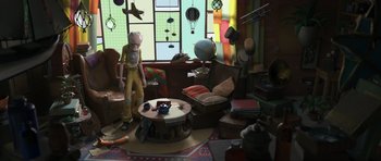 Movie still from “The Little Prince” (2015), directed by Mark Osborne – An old man is standing in a living room; Wide shot, High angle