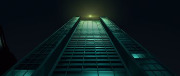 Movie still from “The Little Prince” (2015), directed by Mark Osborne – A tall building is lit up at night time; Extreme Wide shot, Low angle