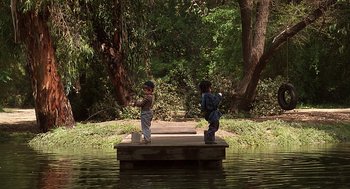 Movie still from “The Little Rascals” (1994), directed by Penelope Spheeris – Two kids are standing on a dock in the middle of the water; Wide shot, Low angle