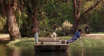 Movie still from “The Little Rascals” (1994), directed by Penelope Spheeris – Two kids and a dog on a dock in the water; Extreme Wide shot, Low angle