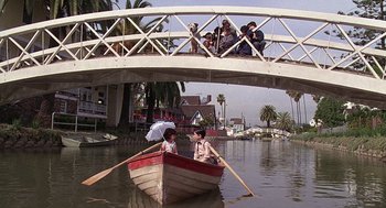 Movie still from “The Little Rascals” (1994), directed by Penelope Spheeris – A group of people riding in a boat on a body of water; Wide shot, High angle