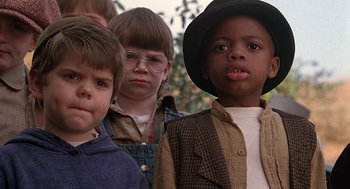 Movie still from “The Little Rascals” (1994), directed by Penelope Spheeris – A group of children standing next to each other; Close Up shot, Low angle