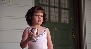 Movie still from “The Little Rascals” (1994), directed by Penelope Spheeris – A little girl holding a can of soda in front of a green door; Close Up shot, Low angle