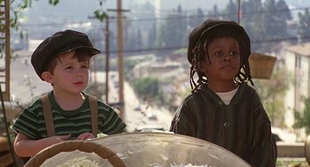 Movie still from “The Little Rascals” (1994), directed by Penelope Spheeris – Two young children sitting next to each other in front of a bowl of rice; Close Up shot, Low angle