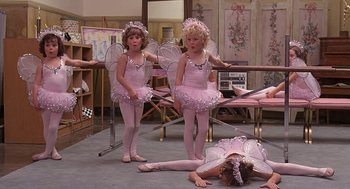 Movie still from “The Little Rascals” (1994), directed by Penelope Spheeris – Two young ballerinas in pink outfits are standing in front of a mirror; Wide shot, High angle