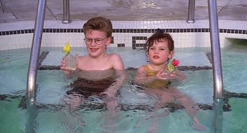 Movie still from “The Little Rascals” (1994), directed by Penelope Spheeris – Two children are in a swimming pool; Medium shot, High angle