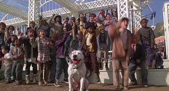 Movie still from “The Little Rascals” (1994), directed by Penelope Spheeris – A group of people and a dog in front of a white gazebo; Wide shot, Low angle