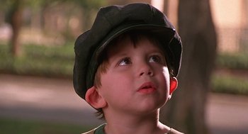 Movie still from “The Little Rascals” (1994), directed by Penelope Spheeris – A little boy wearing a hat looking up at the sky; Close Up shot, Low angle