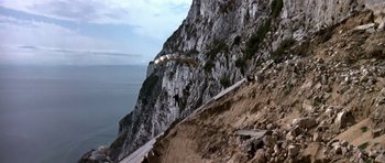 Movie still from “The Living Daylights” (1987), directed by John Glen – A paraglider is flying over a mountain side; Extreme Wide shot, High angle