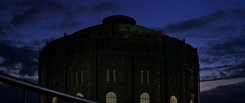 Movie still from “The Living Daylights” (1987), directed by John Glen – A large building with a sky in the background; Extreme Wide shot, Low angle