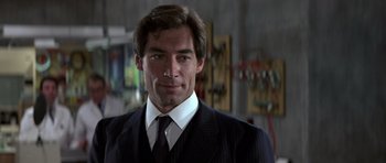 Movie still from “The Living Daylights” (1987), directed by John Glen – A person wearing a suit and tie; Close Up shot, Low angle