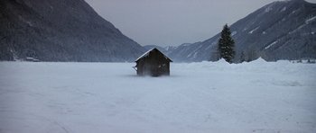 Movie still from “The Living Daylights” (1987), directed by John Glen – A small cabin in the middle of a snow covered field; Extreme Wide shot, High angle