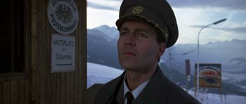 Movie still from “The Living Daylights” (1987), directed by John Glen – A man wearing a uniform and a hat looking to his left; Close Up shot, Low angle