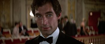 Movie still from “The Living Daylights” (1987), directed by John Glen – A man in a suit and bow tie; Close Up shot, Over the shoulder angle