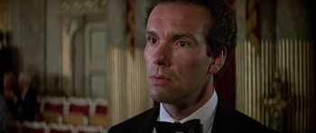Movie still from “The Living Daylights” (1987), directed by John Glen – A person wearing a suit and a bow tie; Close Up shot, Low angle