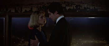 Movie still from “The Living Daylights” (1987), directed by John Glen – A man and a woman are standing in the dark; Close Up shot, Low angle