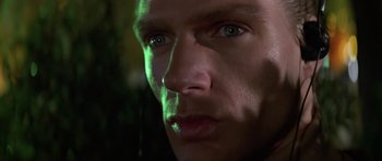 Movie still from “The Living Daylights” (1987), directed by John Glen – A man's face in the dark; Close Up shot, Low angle