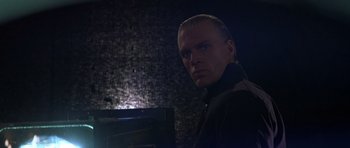 Movie still from “The Living Daylights” (1987), directed by John Glen – A person in a dark room; Close Up shot, Low angle