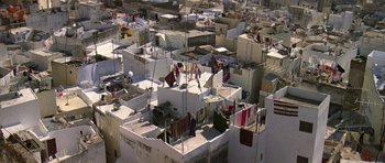 Movie still from “The Living Daylights” (1987), directed by John Glen – A view from above of a city with many buildings and people; Extreme Wide shot, Overhead angle