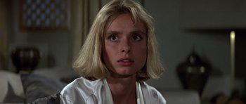 Movie still from “The Living Daylights” (1987), directed by John Glen – A person with blonde hair; Close Up shot, Low angle