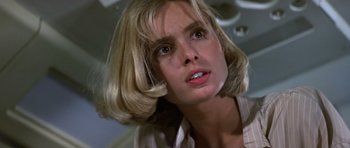 Movie still from “The Living Daylights” (1987), directed by John Glen – A person with short blonde hair; Close Up shot, Low angle