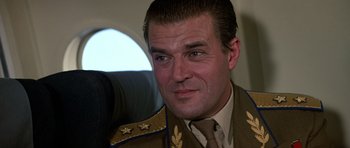 Movie still from “The Living Daylights” (1987), directed by John Glen – A person wearing a military uniform; Close Up shot, Low angle