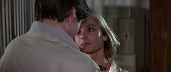 Movie still from “The Living Daylights” (1987), directed by John Glen – A man and a woman looking into each others eyes; Close Up shot, Over the shoulder angle