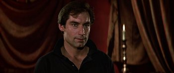Movie still from “The Living Daylights” (1987), directed by John Glen – A person wearing a black shirt; Close Up shot, Low angle