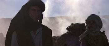 Movie still from “The Living Daylights” (1987), directed by John Glen – A man wearing a helmet and a jacket; Close Up shot, Low angle