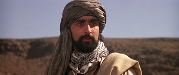 Movie still from “The Living Daylights” (1987), directed by John Glen – A man with a beard wearing a turban; Close Up shot, Low angle
