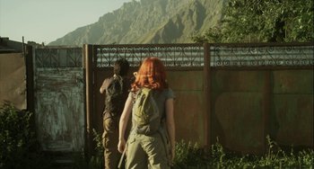 Movie still from “The Loneliest Planet” (2011), directed by Julia Loktev – Two people with backpacks walking near a fence; Wide shot, Over the shoulder angle