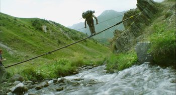 Movie still from “The Loneliest Planet” (2011), directed by Julia Loktev – A man walking across a bridge over a river; Wide shot, Low angle