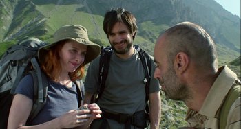 Movie still from “The Loneliest Planet” (2011), directed by Julia Loktev – A man and a woman looking at a man with a cell phone in his hand; Medium shot, Over the shoulder angle