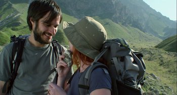 Movie still from “The Loneliest Planet” (2011), directed by Julia Loktev – A man and a woman are talking on a mountain top; Medium shot, Low angle
