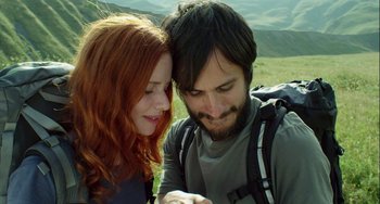 Movie still from “The Loneliest Planet” (2011), directed by Julia Loktev – A man and a woman looking at a cell phone; Close Up shot, Low angle