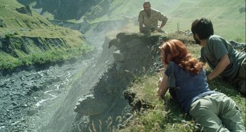 Movie still from “The Loneliest Planet” (2011), directed by Julia Loktev – A man and a woman sitting on top of a cliff; Wide shot, High angle