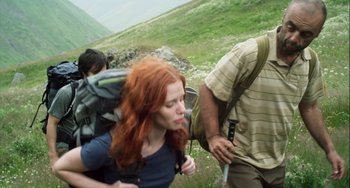 Movie still from “The Loneliest Planet” (2011), directed by Julia Loktev – A group of people walking up a hill with backpacks; Medium shot, Low angle